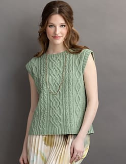 Woman in green cable knit sleeveless sweater