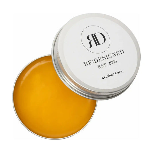 RE:DESIGNED Leather Care balm tin open showing amber beeswax balm