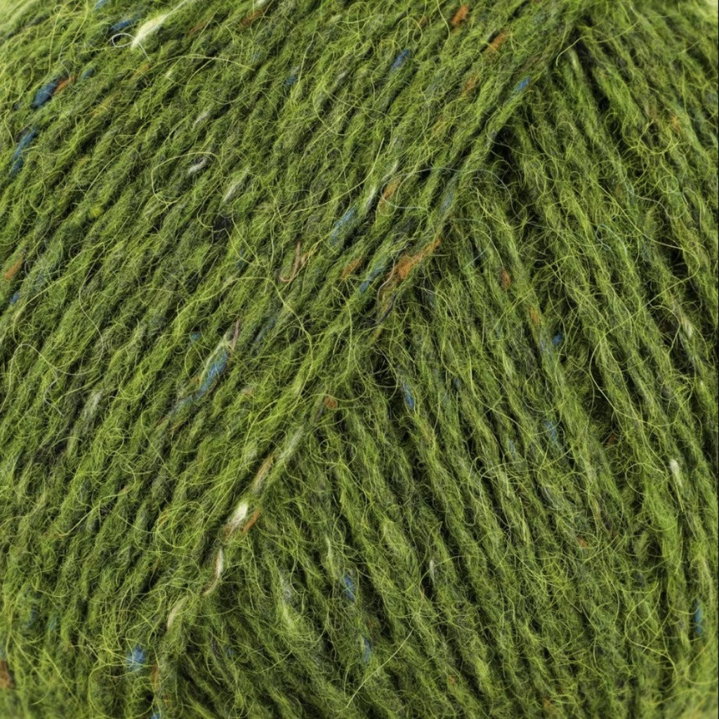 Lotus Leaf 205: A heathered tweed yarn in a yellow green color with flecks of blue, orange and white