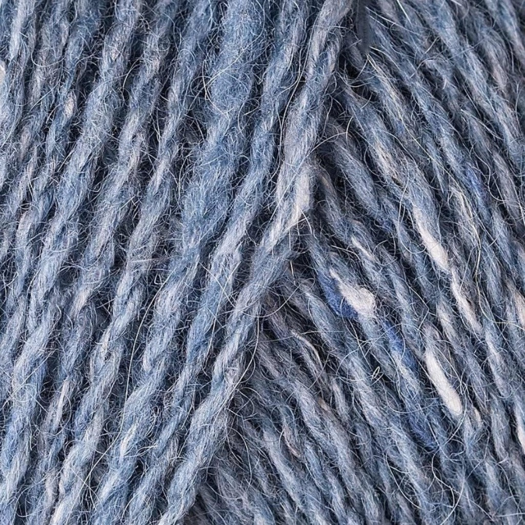 Maritime 167: A heathered tweed yarn in a dusty sky blue color with flecks of white.