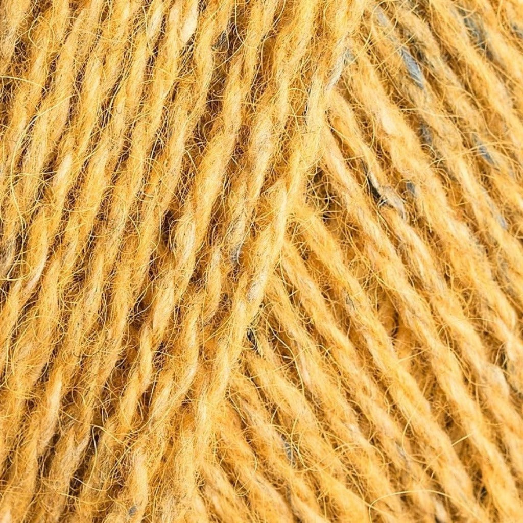 Mineral 181: A heathered tweed yarn in a bright marigold yellow color with flecks of blue and white.