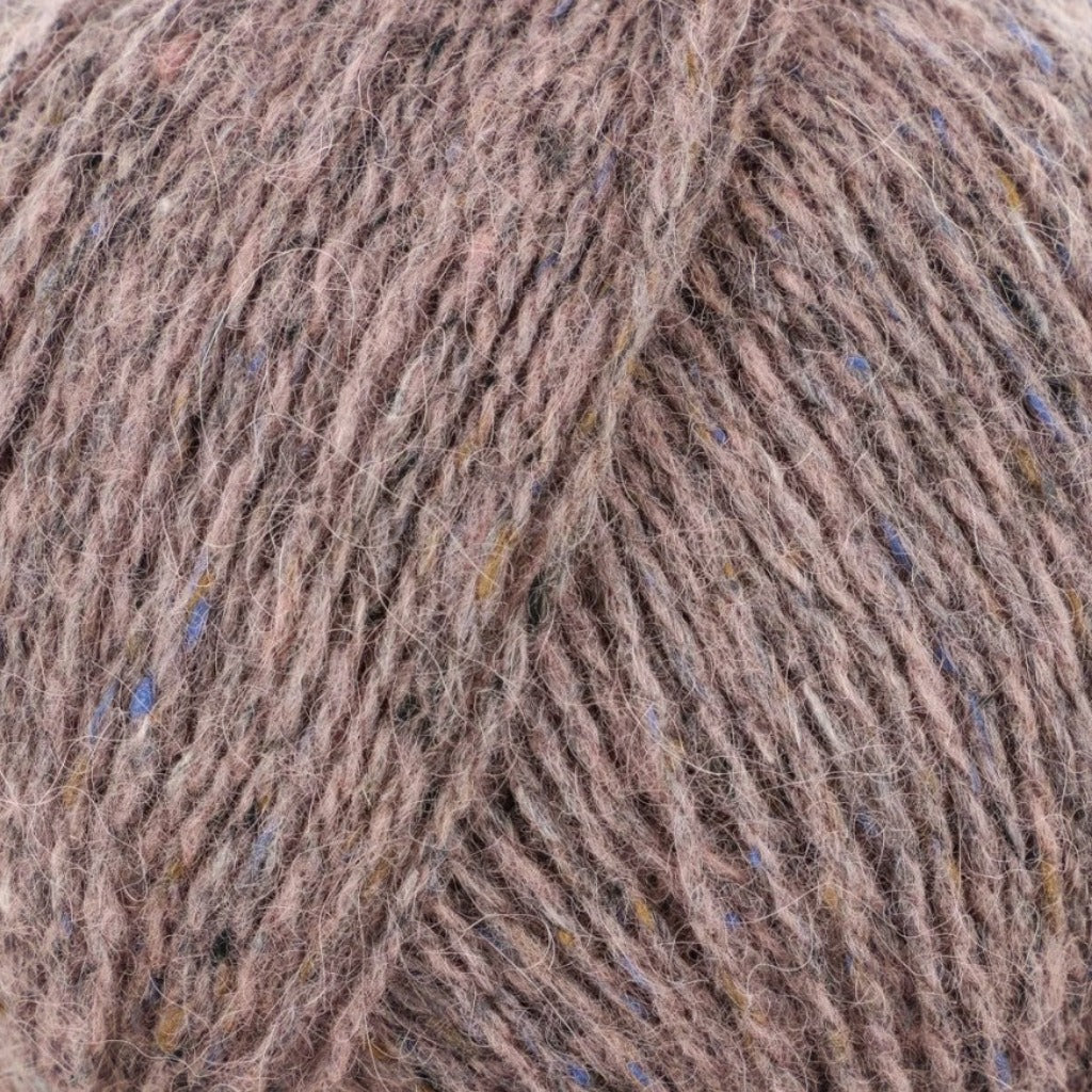 Rose Quartz 206: A heathered tweed yarn in a pale, dusty pink color with flecks of orange and blue.