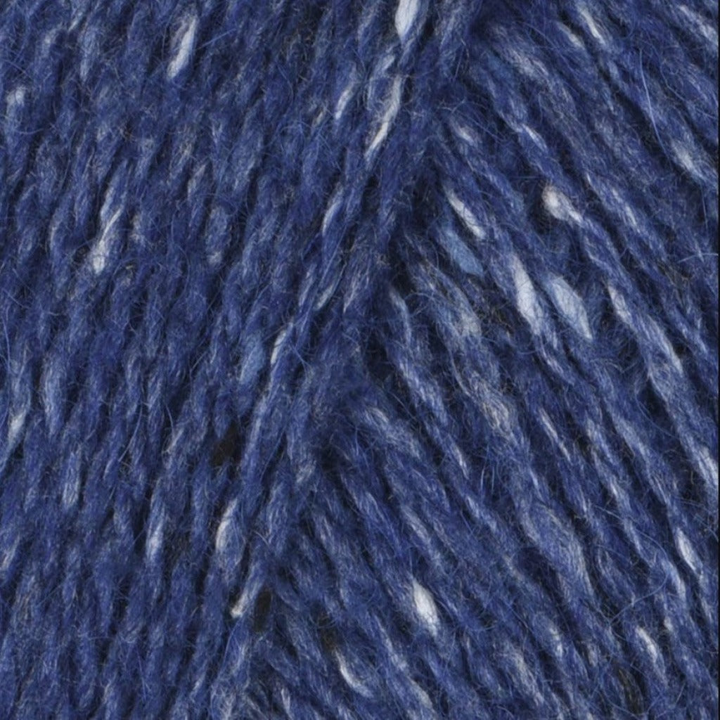 Ultramarine 214: A heathered tweed yarn in a medium navy blue color with flecks of white.