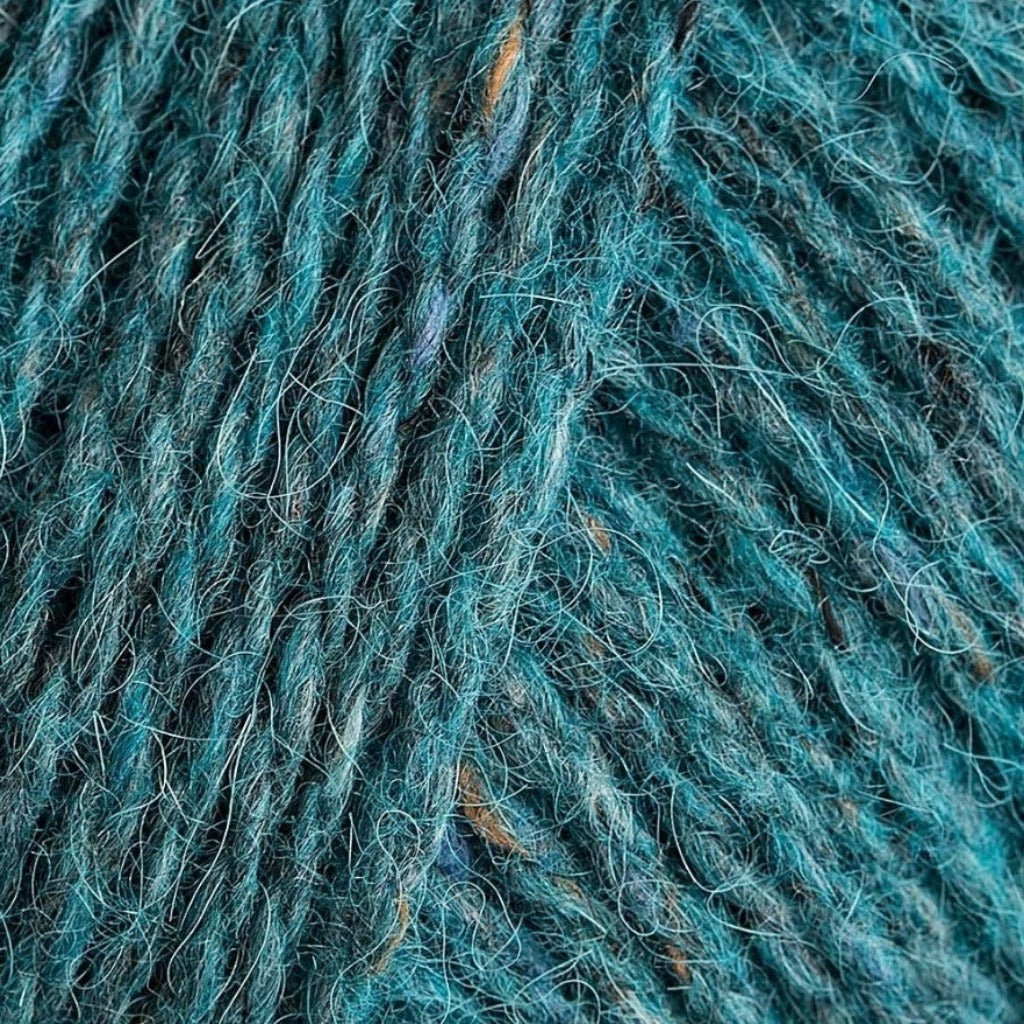 Watery 152: A heathered tweed yarn in a medium aqua blue color with flecks of brown.