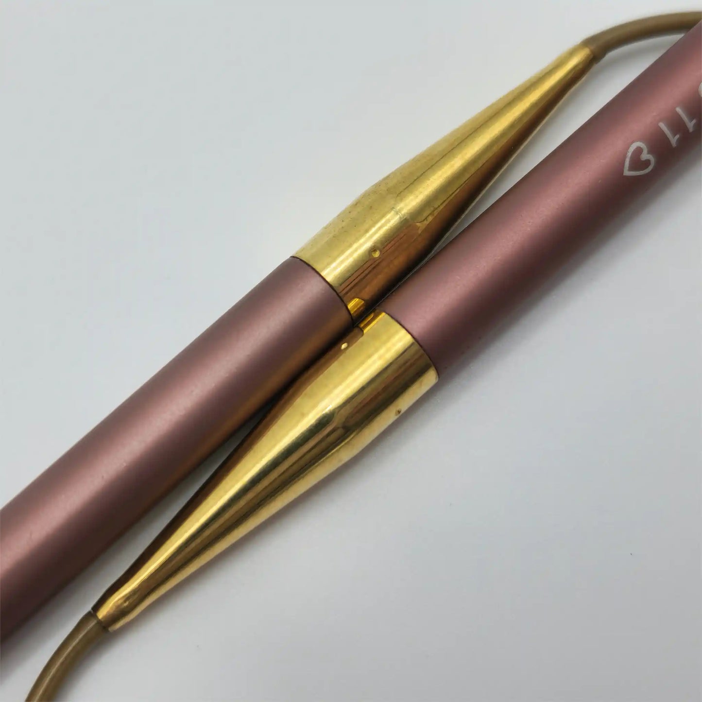 Closeup of the Addi Mystic Rockets, showing the anodized mauve tips fitting into the brass ferrules