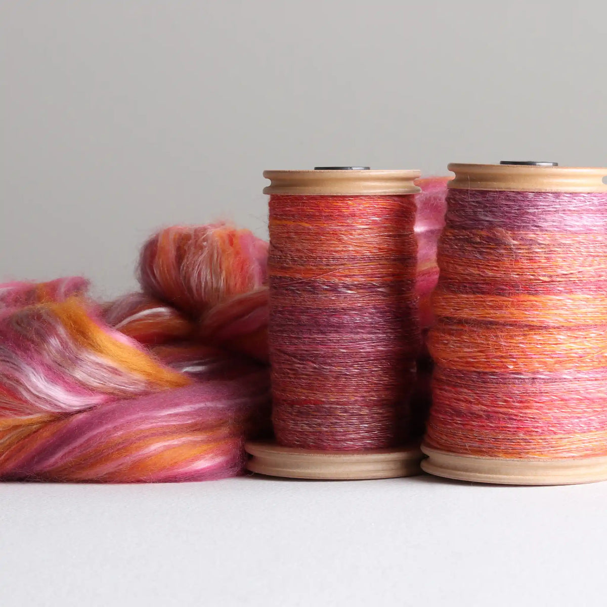 Two Ashford single drive Standard Bobbins filled with handspun yarn