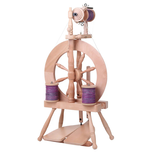 Traveller 3 Spinning Wheel with bobbins full of purple yarn and a lacquered finish