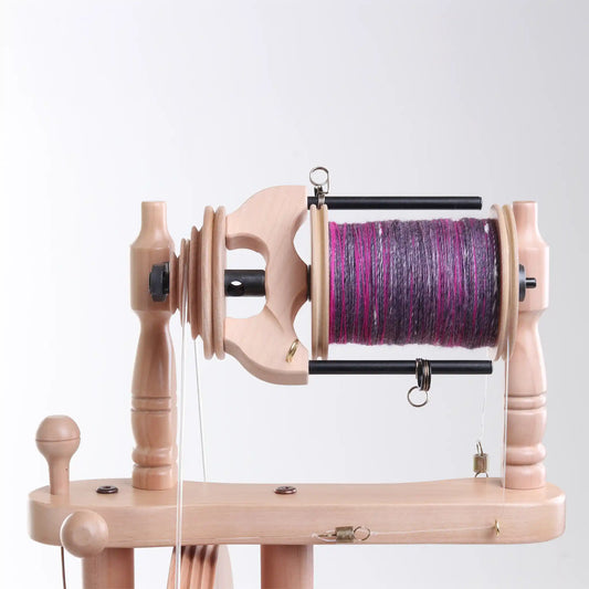 Wooden Traveller 3 bobbin with purple yarn on a white background