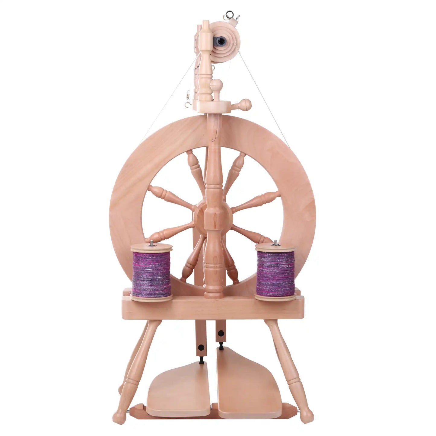 Wooden Traveller 3 spinning wheel with two bobbins of purple yarn on a white background
