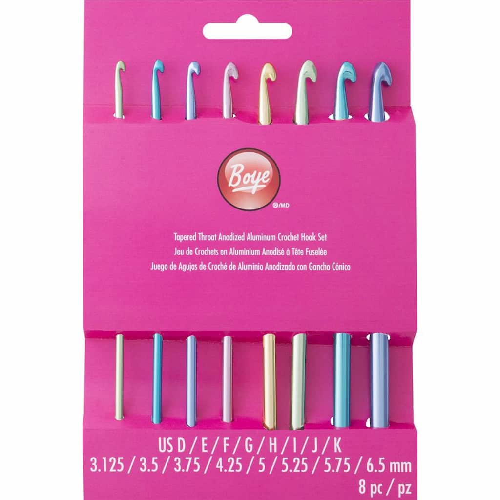 A set of eight differently colored crochet hooks side by side in a wall display.
