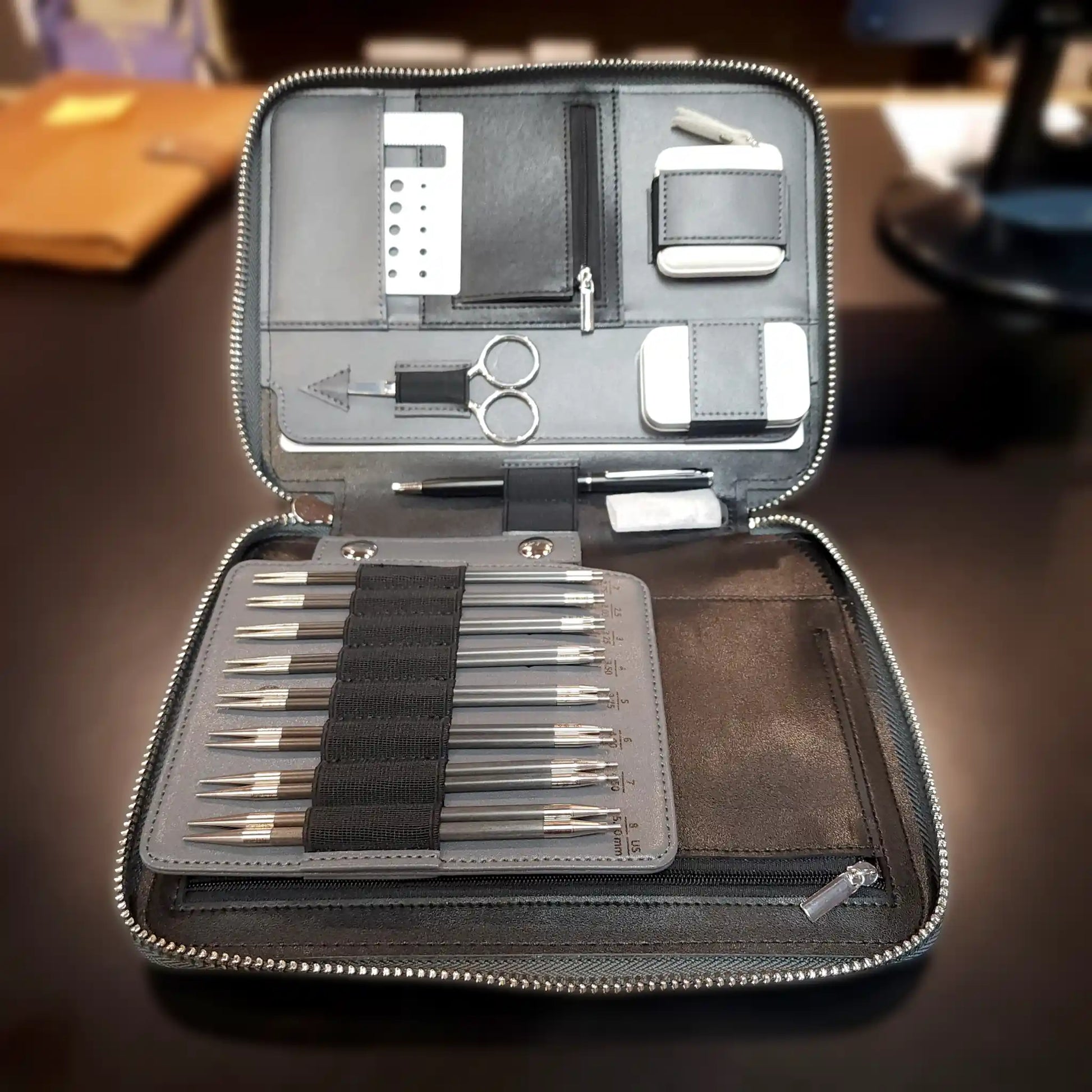 ChiaoGoo Forté 2.0 case open and propped on a wood desk, needle tips and tools ready to use