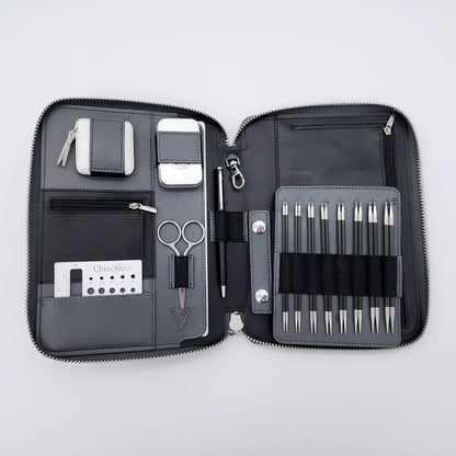 ChiaoGoo Forté 2.0 case open flat with carbon-fiber tips on the needle board, scissors, pen, gauge and tape measure