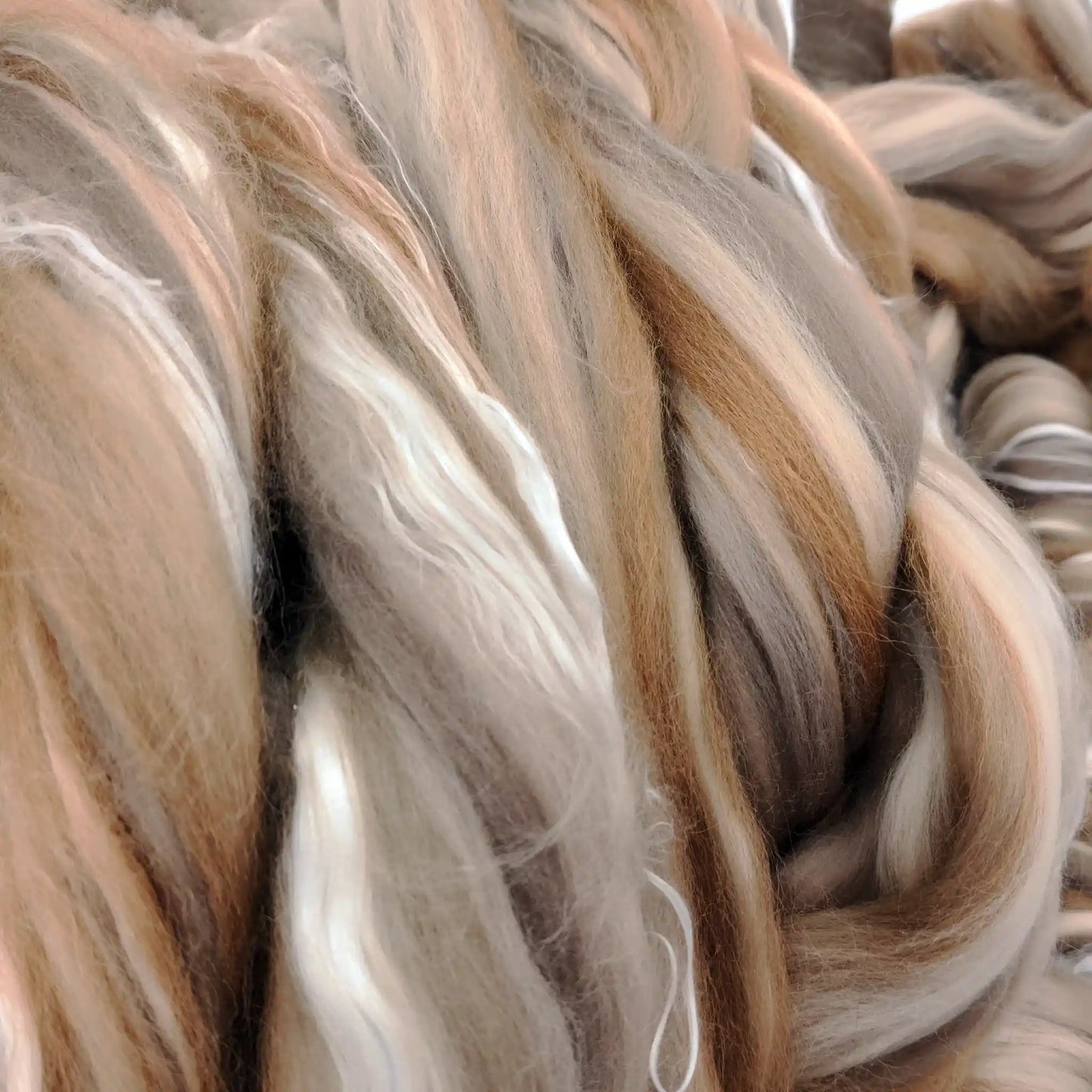 Close up of Chocolate Malt White Silk blend top showing bright mulberry silk catching the light against the merino