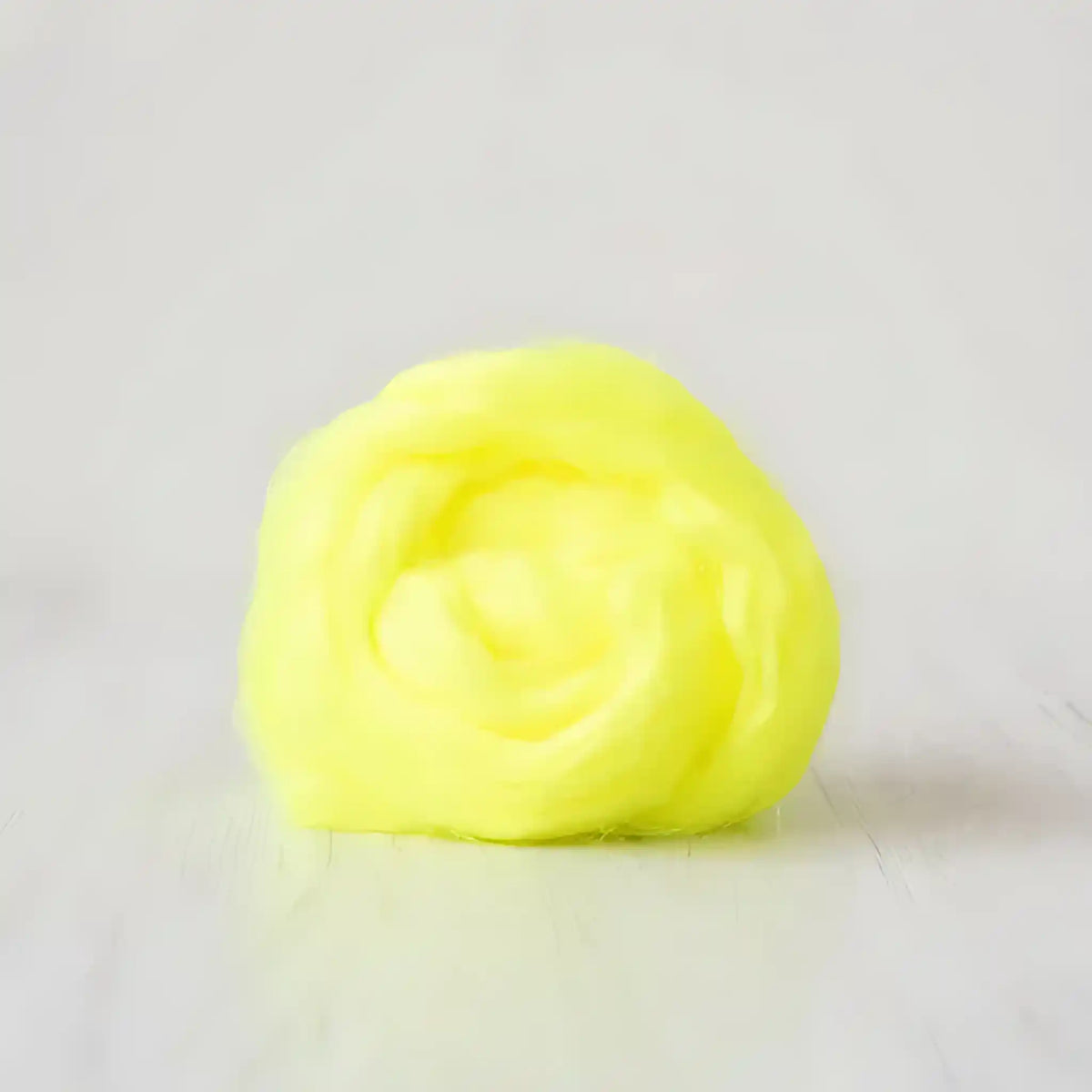 Coil of neon yellow Firestar nylon top sparkle fiber by Paradise Fibers