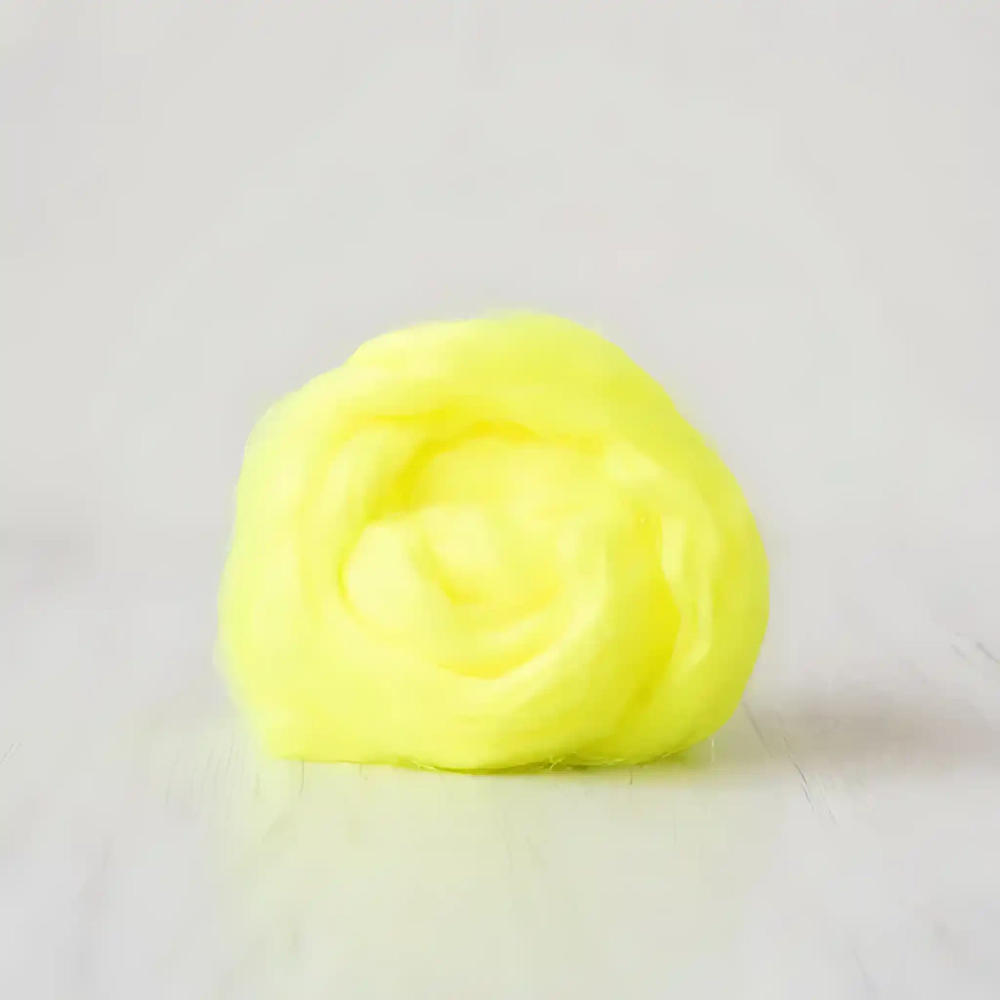 Coil of neon yellow Firestar nylon top sparkle fiber by Paradise Fibers