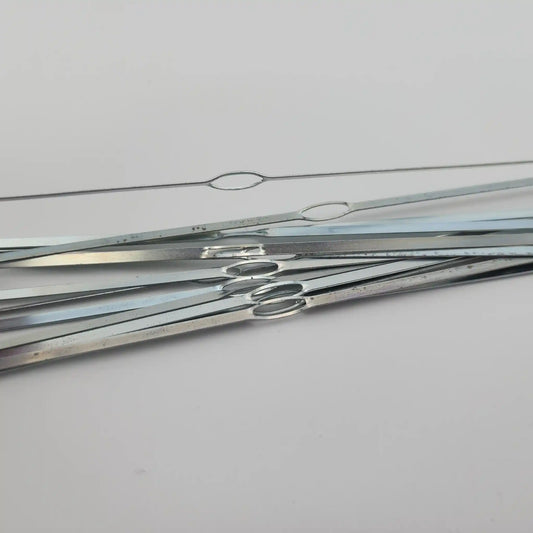 Close view of the closed oval eye on a flat steel weaving heddle