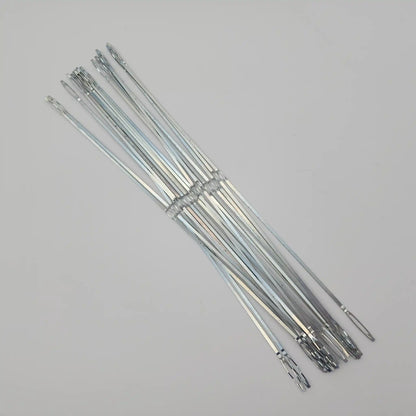 Flat steel weaving heddles fanned out to show the full length and end loops