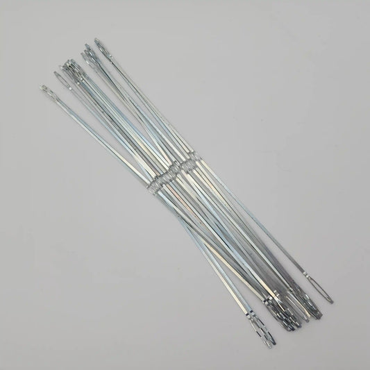 Flat steel weaving heddles fanned out to show the full length and end loops