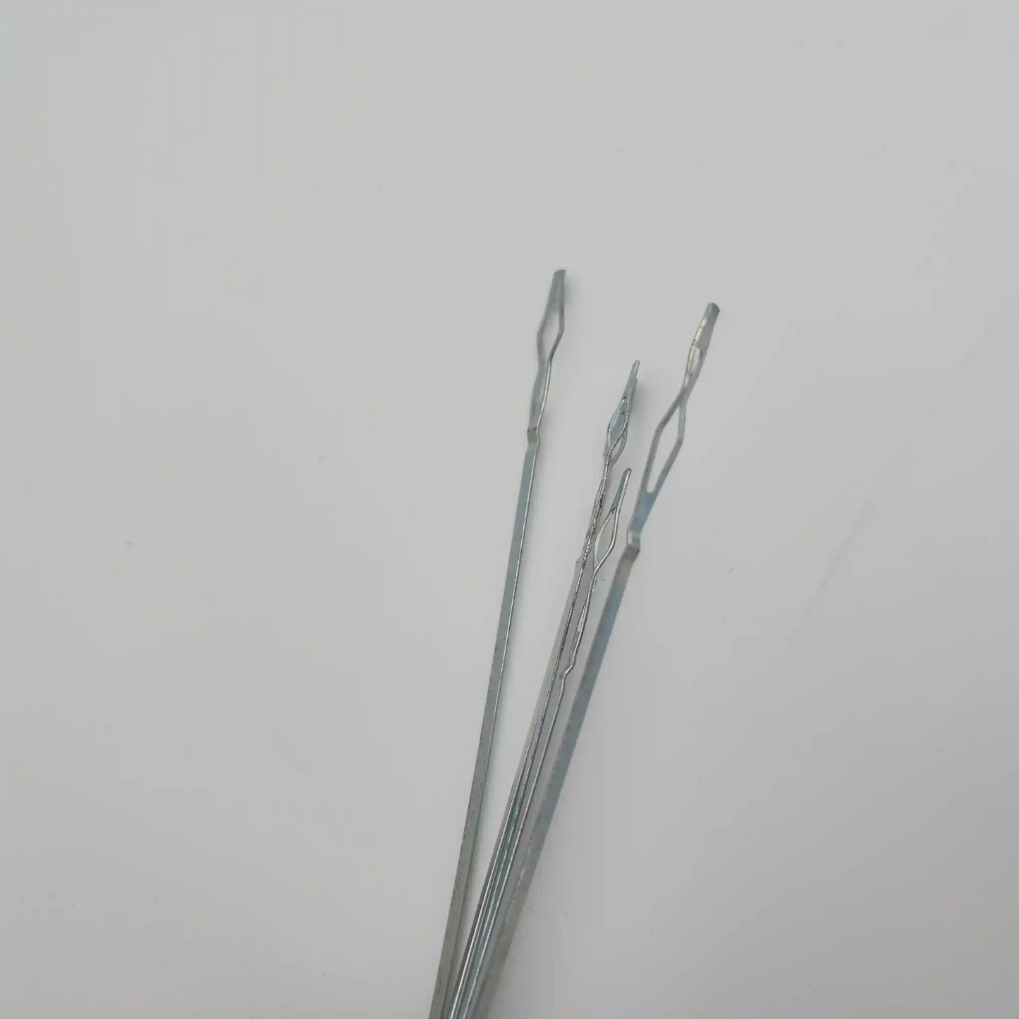 Close view of the sprung end loops on flat steel weaving heddles
