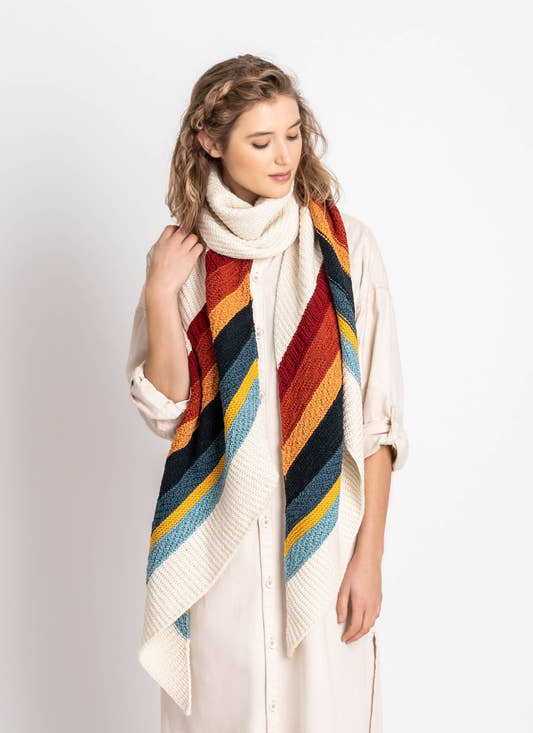 Gresham Wrap looped at the neck, showing diagonal textured stripes in red, rust, orange, navy, blue, gold and pale blue