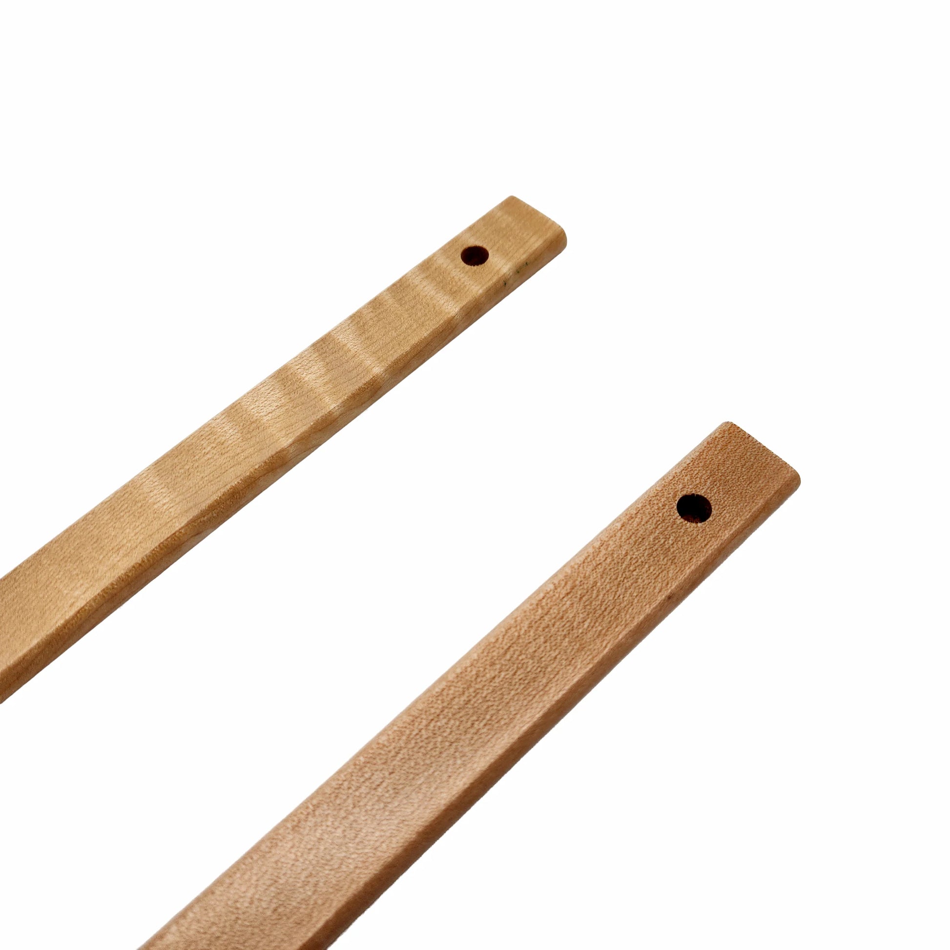 Two finished lease sticks with holes on a white background