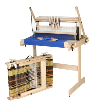 Louet Jane 8 shaft table loom on its floor stand beside a second Jane folded flat with the warp still on