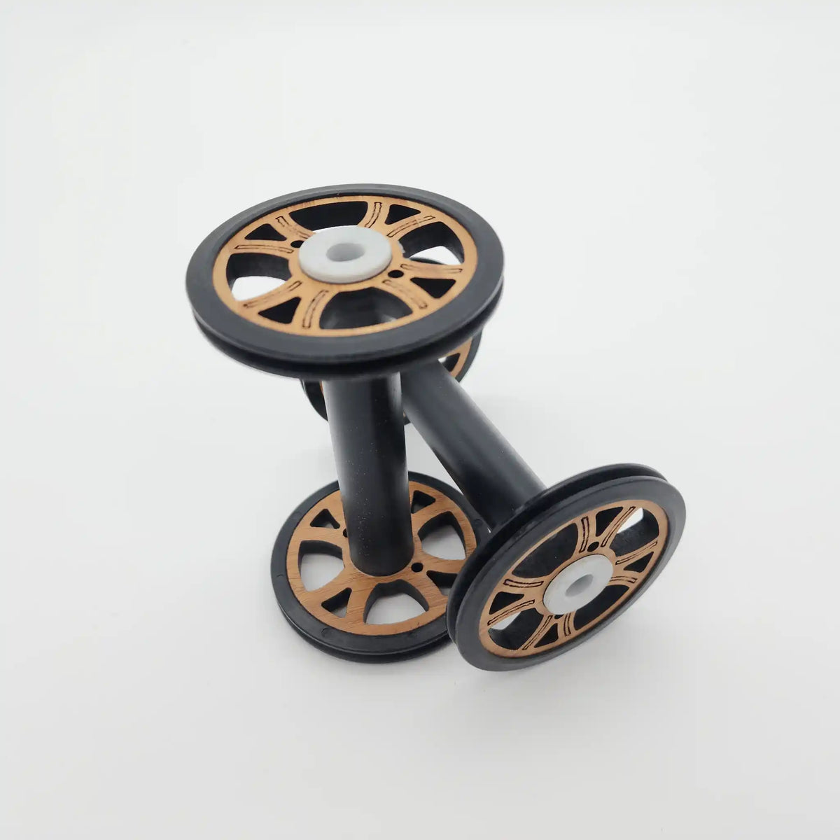 Two Majacraft Baby wood bobbins, showing the bamboo flange faces and the black barrel