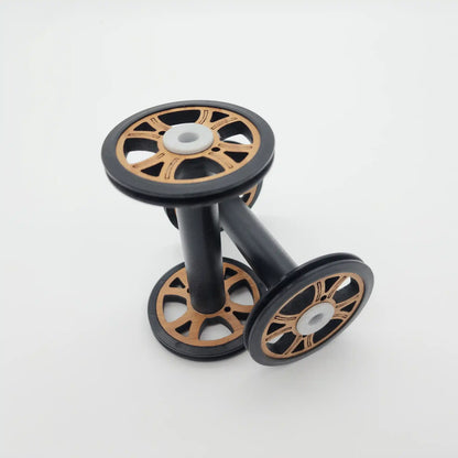 Two Majacraft Baby wood bobbins, showing the bamboo flange faces and the black barrel