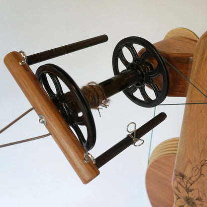 Closeup of a bobbin and flyer on the Majacraft Suzie Spinning Wheels