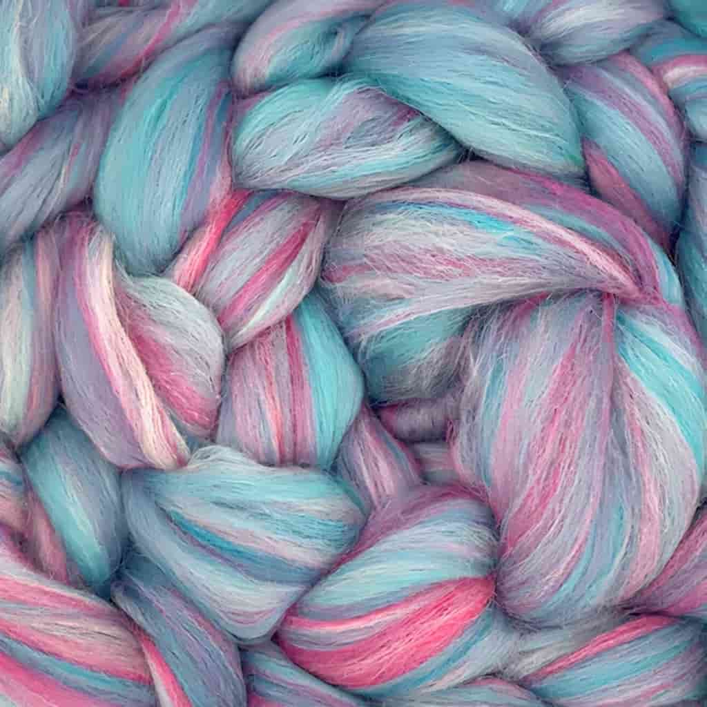 A fiber with colors consisting of various shades of red or pink, of light blue, and white mixed together.