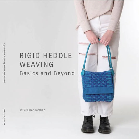 Rigid heddle weaving basics book cover with blue woven bag.