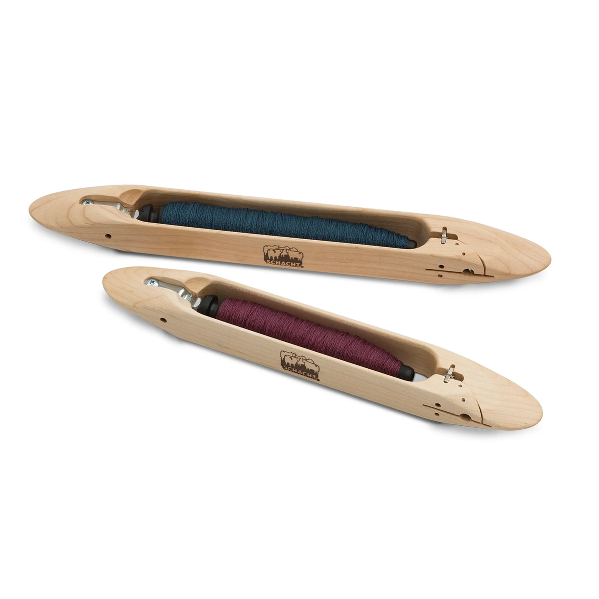 Schacht 12 inch and 15 inch end delivery shuttles side by side, each loaded with a wound pirn
