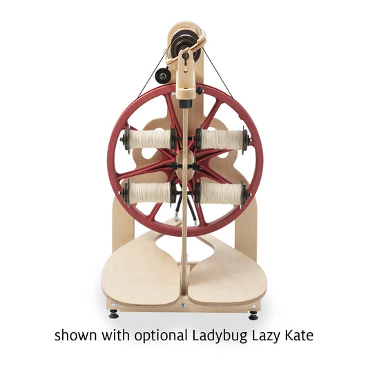 Schacht Ladybug Lazy Kate mounted on a Ladybug spinning wheel, holding four bobbins