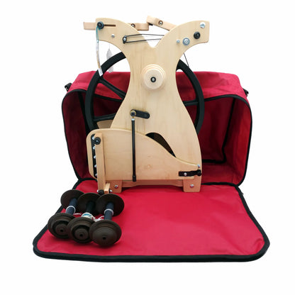 Schacht Sidekick standing upright next to a travel bag with three bobbins