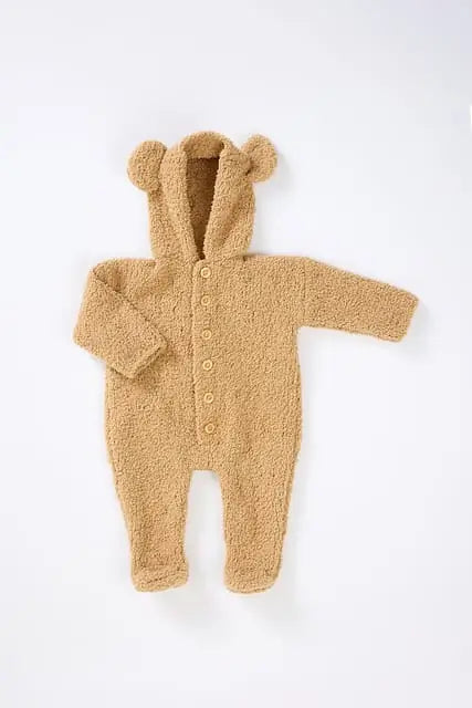 Brown baby onesie with bear ears and buttons on a white background