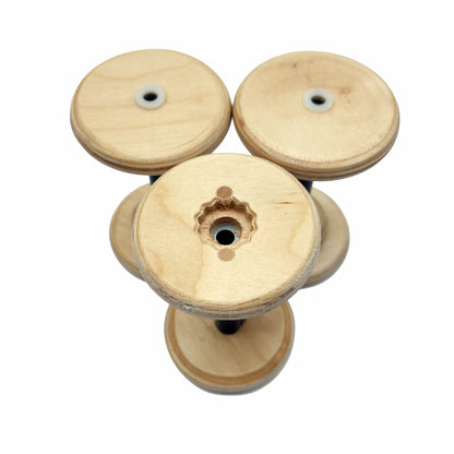 Three SpinOlution 4oz Baltic birch bobbins shown from both ends