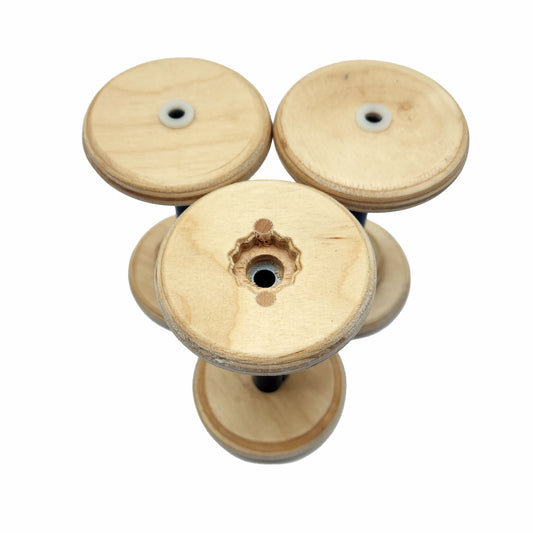 Three SpinOlution 4oz Baltic birch bobbins shown from both ends