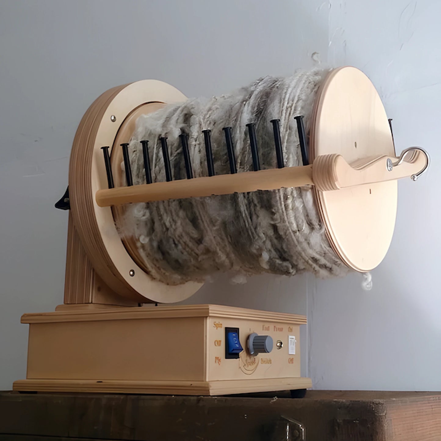 SpinOlution 64oz bobbin mounted on a Firefly wheel full of yarn
