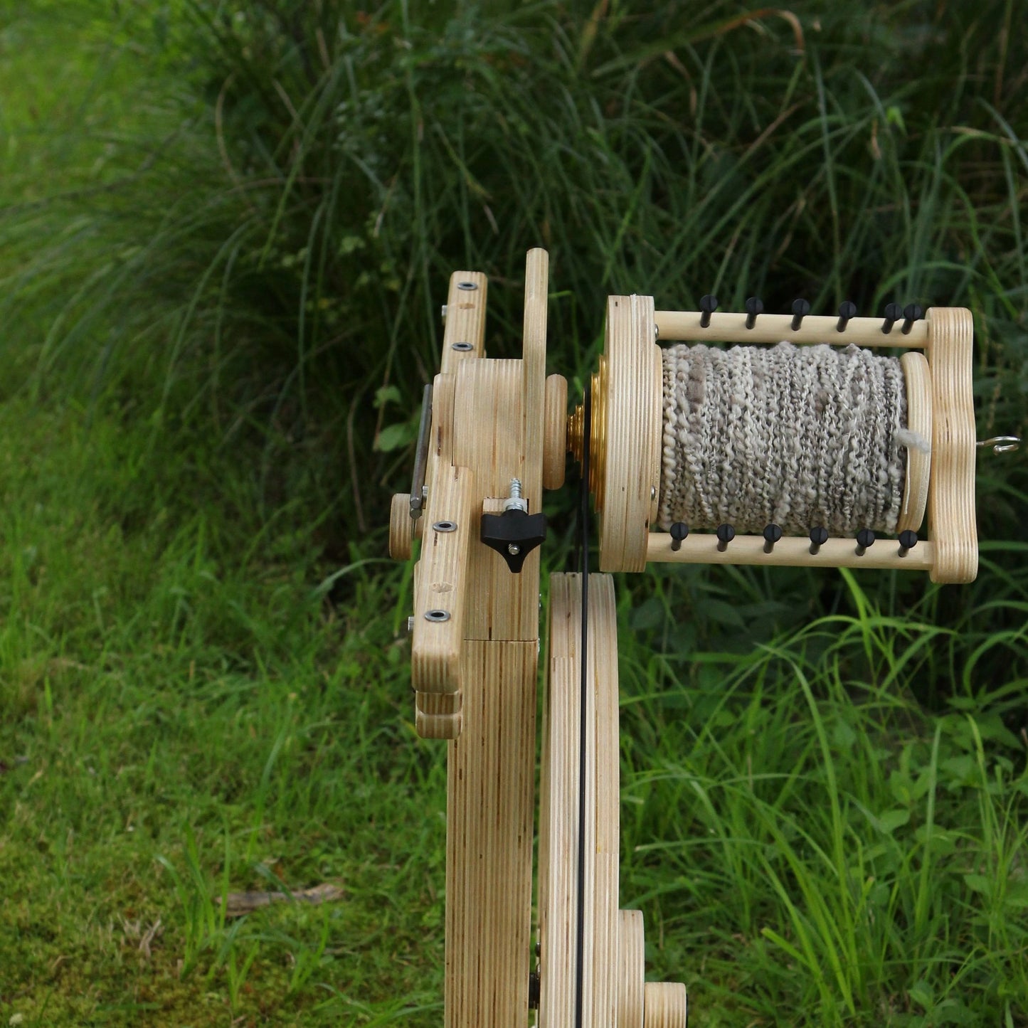 SpinOlution Monarch flyer head with bobbin mounted on the wheel