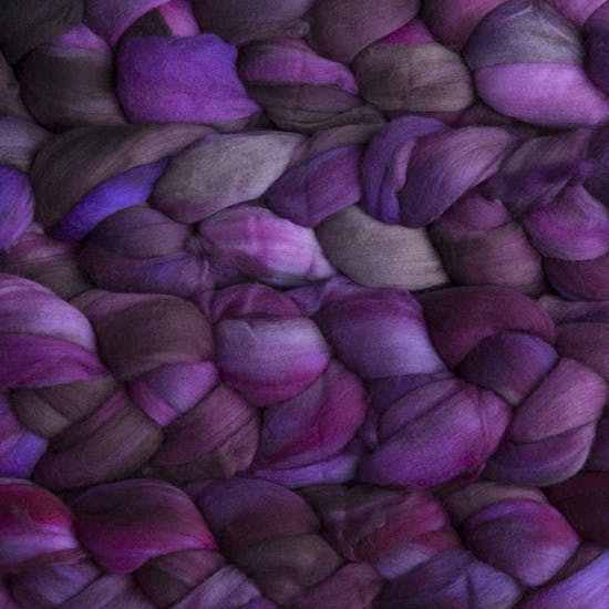 Color 136 Sabiduria. A handyed merino top with shades of plum, violet, claret, grey, and fuschia.