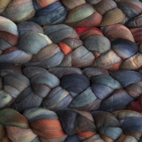 Color 0139 Pocion. A handyed merino top with shades of denim blue, terra cotta, scarlet, mint green, and duck egg.