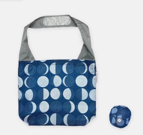 Flip & Tumble tote style bag laid flat with a printed pattern of moon cycles.