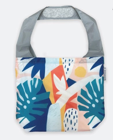 Flip & Tumble tote style bag laid flat with a printed pattern of jungle foliage. 