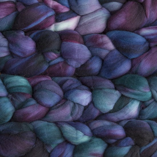 Color 247 Whale's Road. A handyed merino top with shades of slate grey, cyan, deep purple, and deep blue.