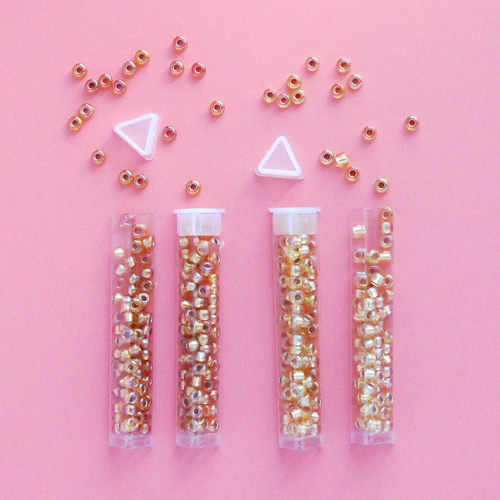 Miyuki seed beads size 6/0 in a triangle holding tube.