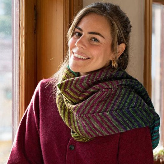 Chevron Scarf knit up from kit #3012 on a smiling model.