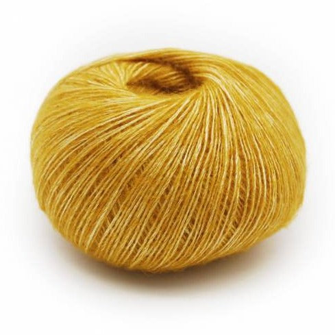 Wound ball of Mirasol Inka yarn in a slightly shiny gold color.