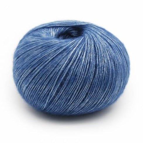 Wound ball of Mirasol Inka yarn in a slightly shiny sapphire/blue color.