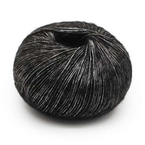 Wound ball of Mirasol Inka yarn in a slightly shiny black/dark grey color.