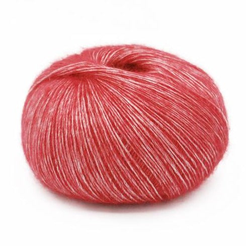 Wound ball of Mirasol Inka yarn in a slightly shiny carnelian/coral color. 